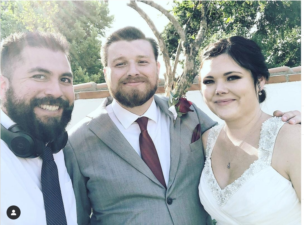 Mike Jay with bride and groom at outdoor wedding